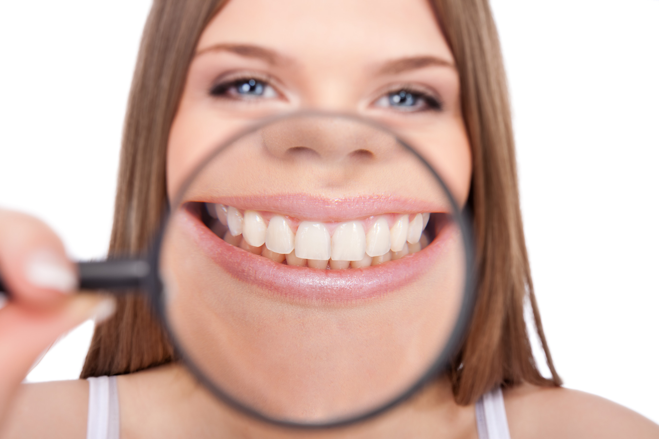 young woman showing her healthy teeth, isolated over white background